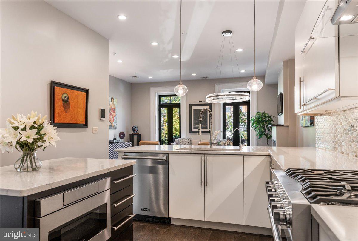 20 East Court Street Doylestown, PA 18901 - Photo 13 of 34 a kitchen with stainless steel appliances granite countertop a sink and cabinets