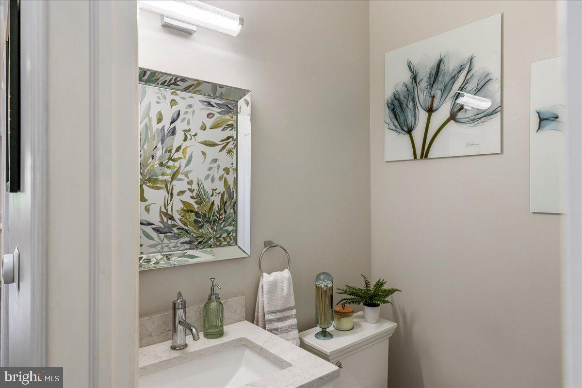 20 East Court Street Doylestown, PA 18901 - Photo 16 of 34 a bathroom with a shower curtain a sink and a mirror