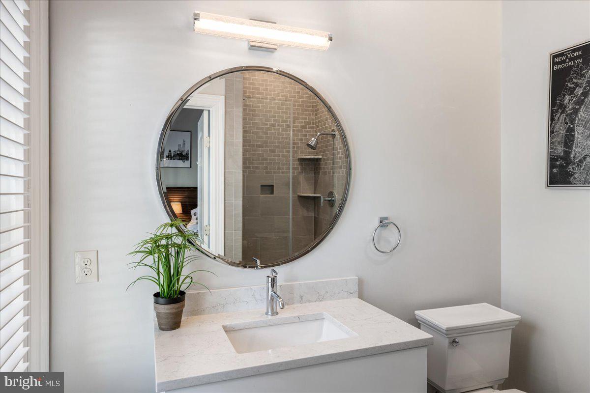 20 East Court Street Doylestown, PA 18901 - Photo 20 of 34 a bathroom with a sink and mirror