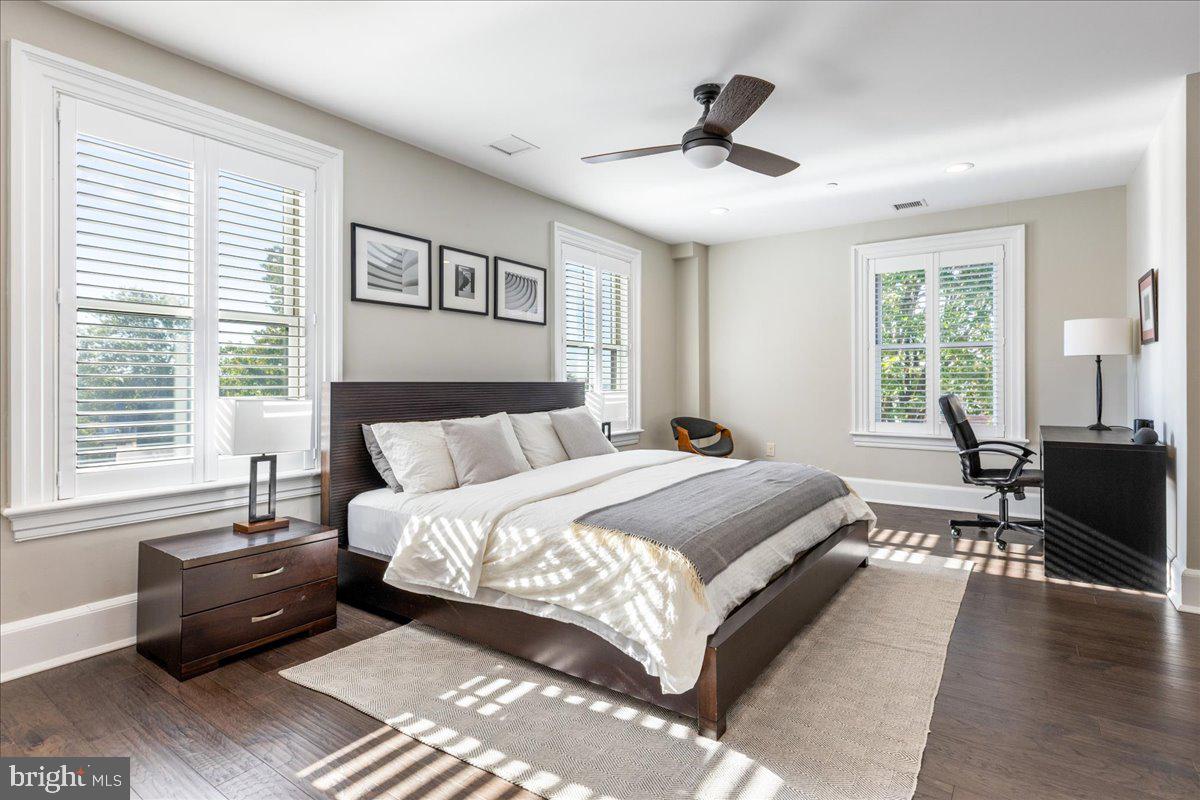 20 East Court Street Doylestown, PA 18901 - Photo 26 of 34 a spacious bedroom with a large bed and a chandelier