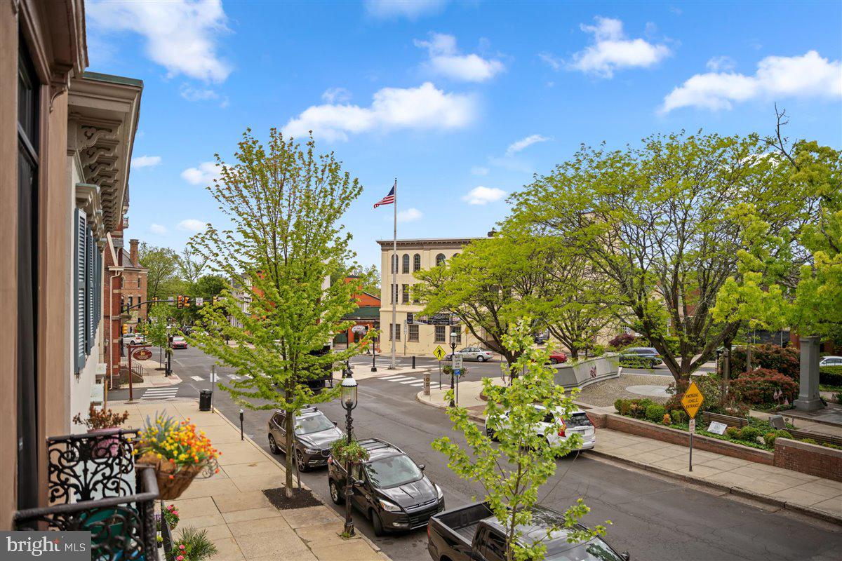 20 East Court Street Doylestown, PA 18901 - Photo 32 of 34 a view of a flower garden with a bench