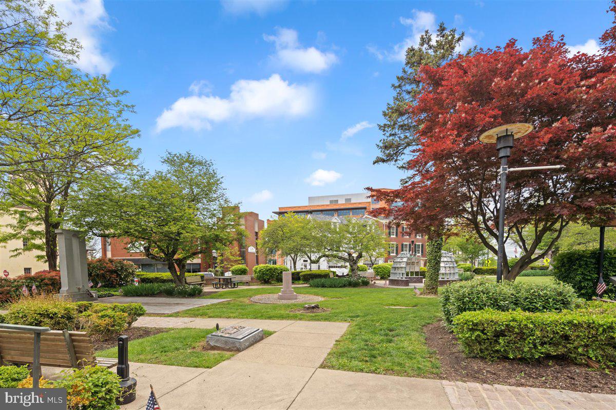 20 East Court Street Doylestown, PA 18901 - Photo 33 of 34 a view of a fountain in front of a brick house with large windows