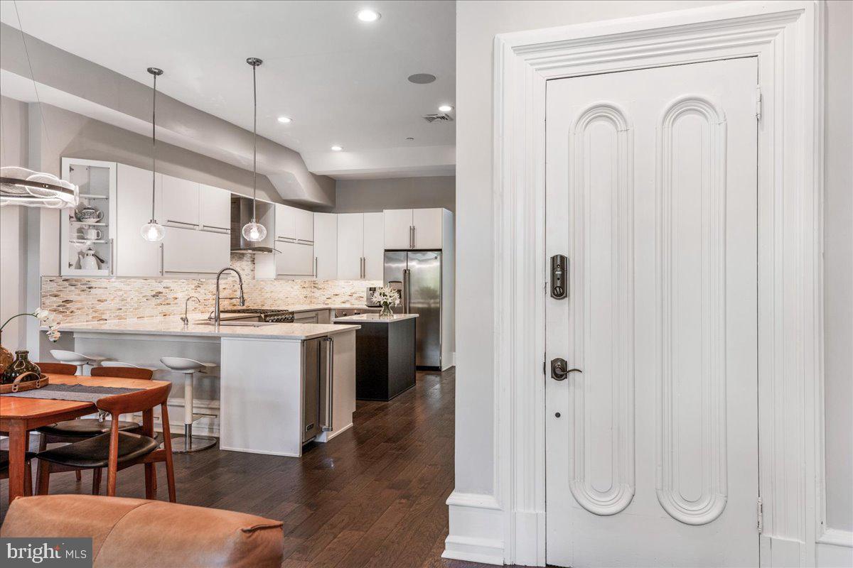 20 East Court Street Doylestown, PA 18901 - Photo 4 of 34 a kitchen with stainless steel appliances granite countertop a refrigerator a sink dishwasher a stove and white cabinets with wooden floor