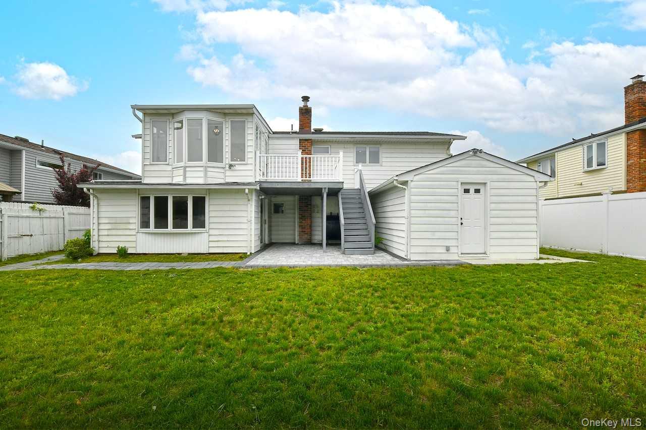 107 Beverly Road Massapequa, NY 11758 - Photo 30 of 41 a front view of a house with a garden