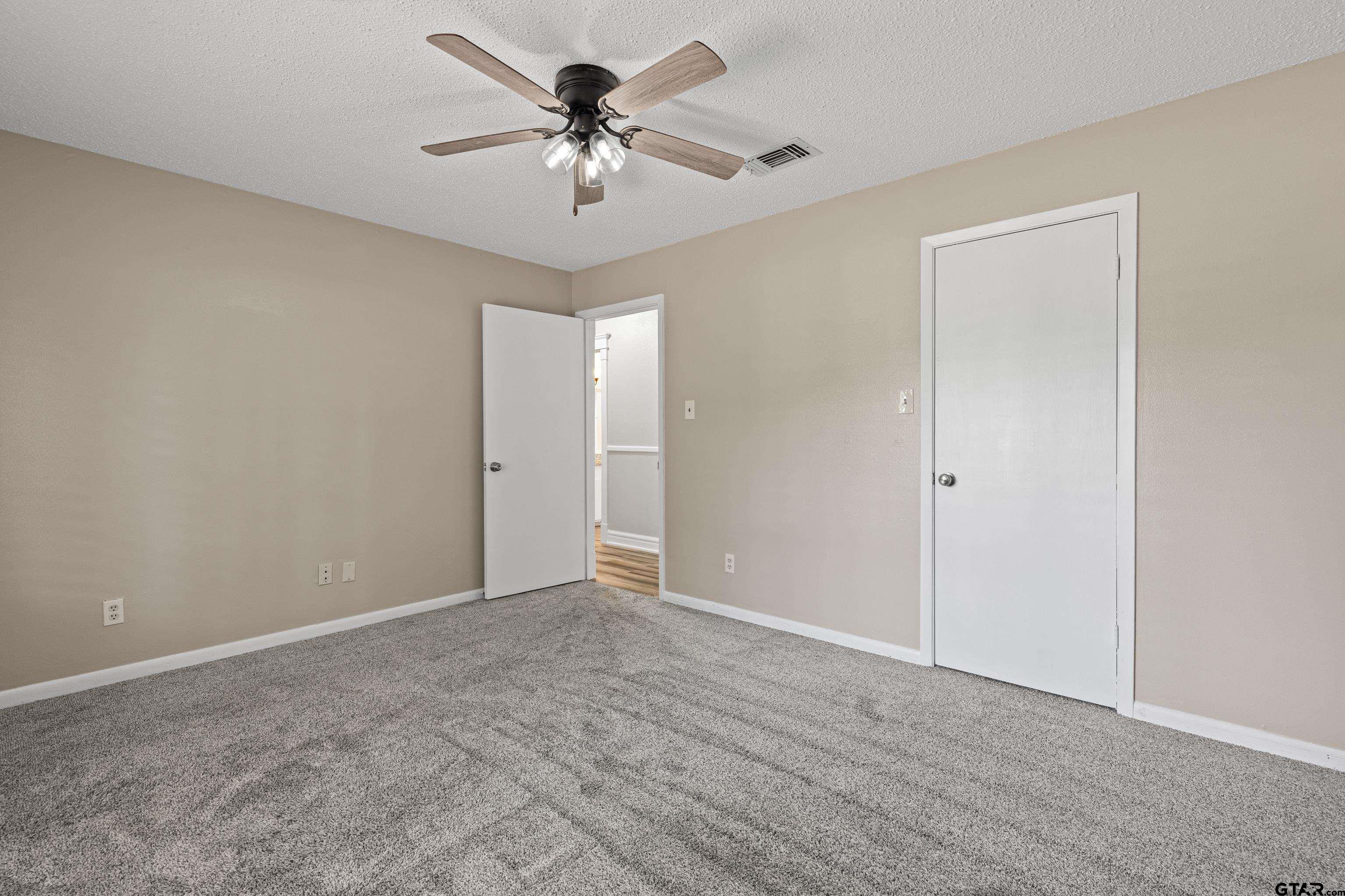 1821 Azalea Street Gilmer, TX 75644 - Photo 24 of 34 a view of an empty room with a chandelier fan