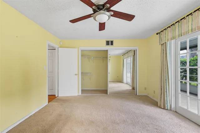 a view of a big room with wooden floor and a ceiling fan