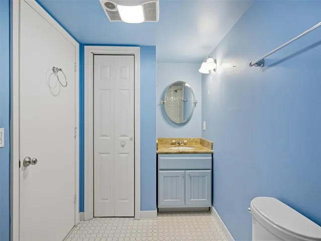 a view of bathroom with toilet a sink and a mirror