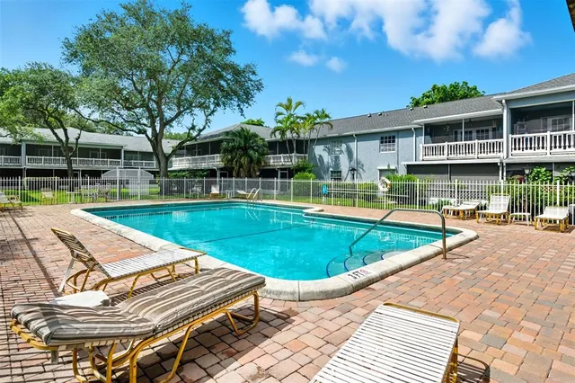 a view of a house with swimming pool and sitting area