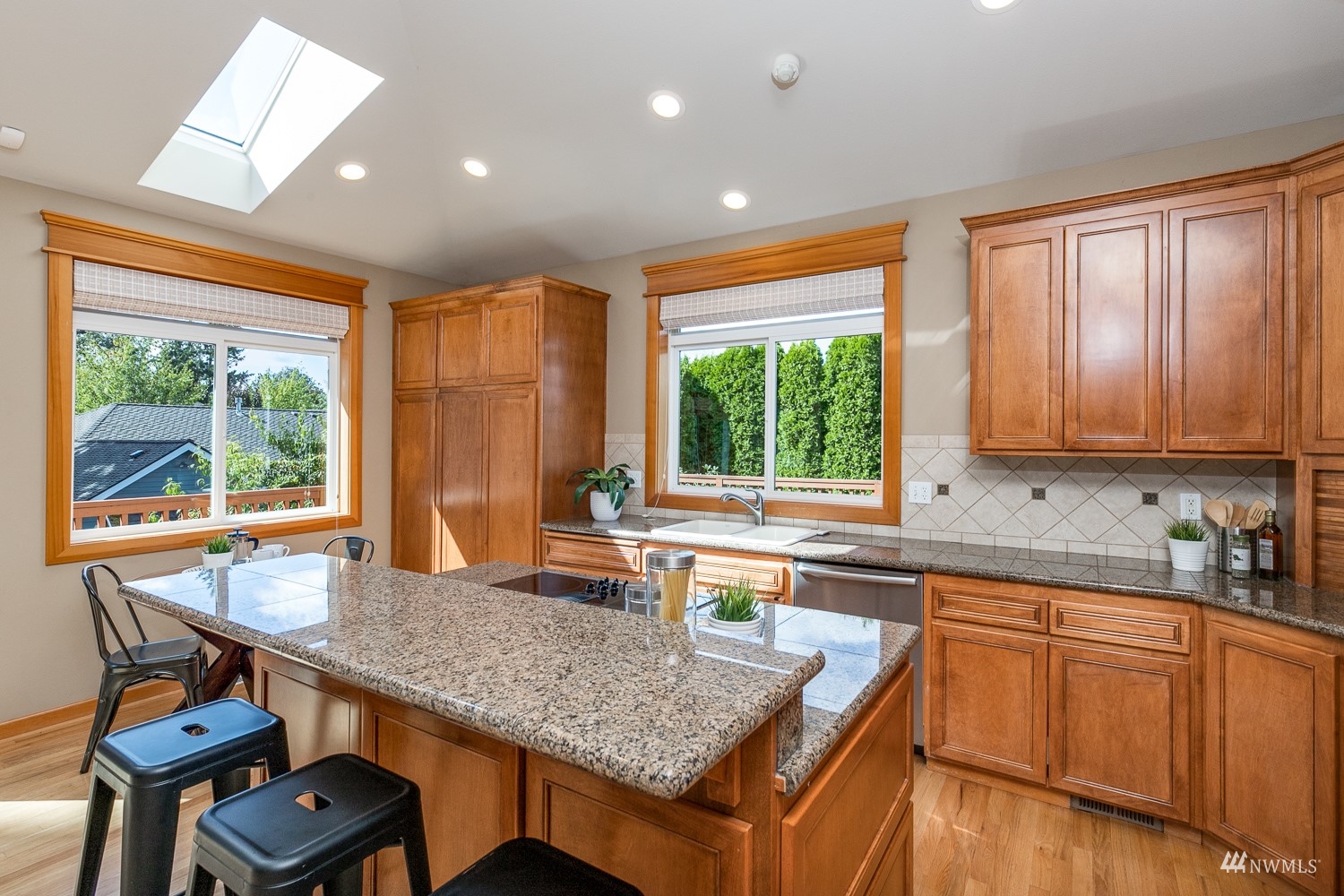 24222 23rd Avenue Southeast Bothell, WA 98021 - Photo 22 of 40 a kitchen with stainless steel appliances granite countertop sink stove and microwave
