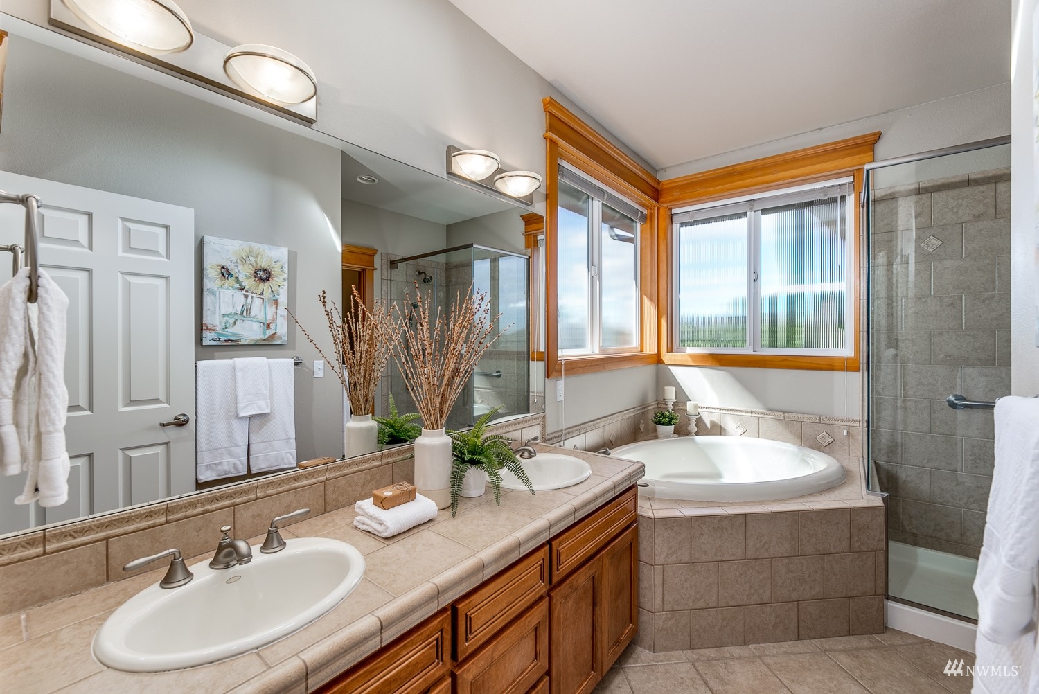24222 23rd Avenue Southeast Bothell, WA 98021 - Photo 36 of 40 a bathroom with a tub double sink window and mirror