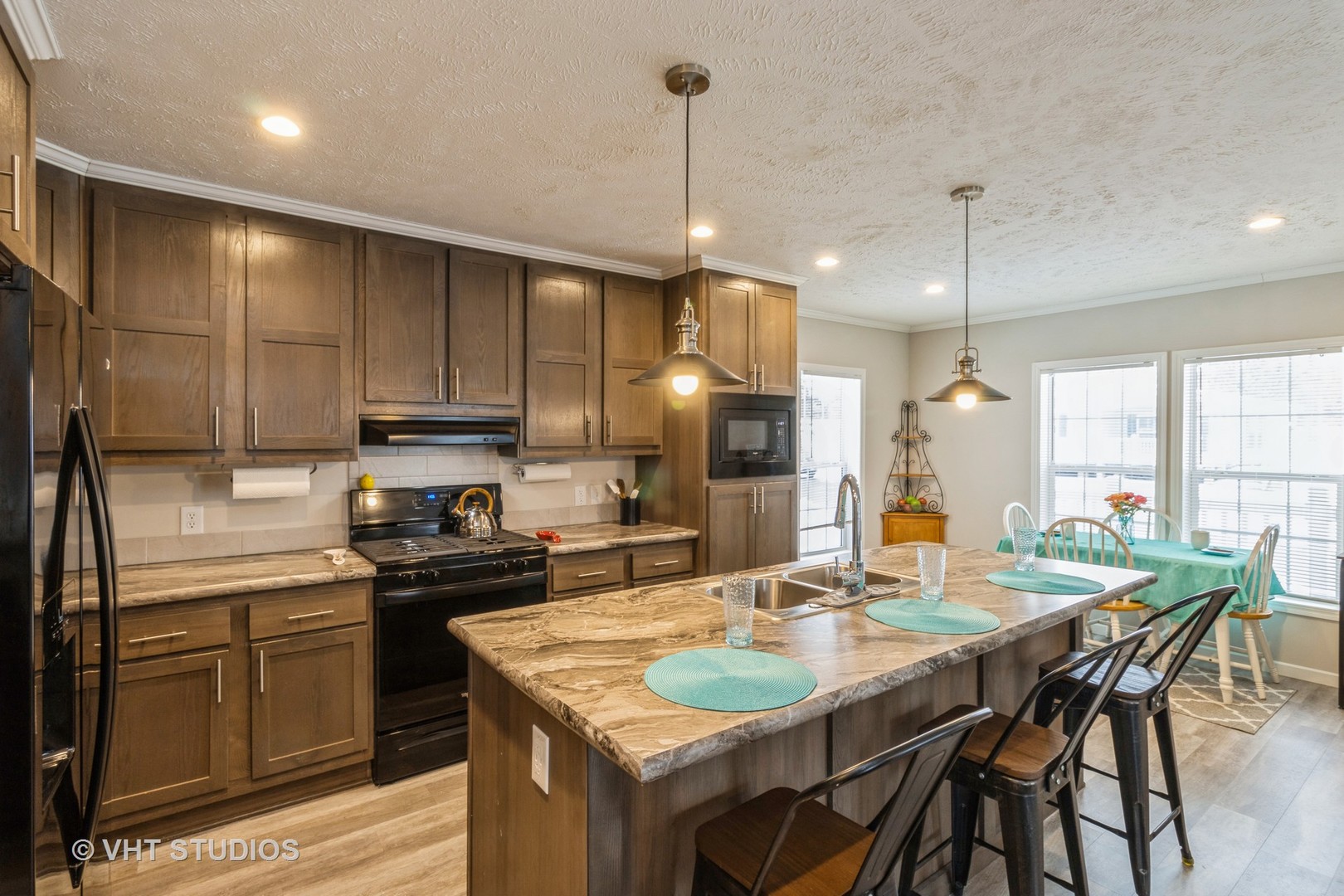 205 Tollview Road Elgin, IL 60123 - Photo 7 of 19 a kitchen with kitchen island granite countertop a sink stove and refrigerator with wooden floor