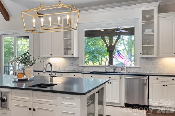 a kitchen with granite countertop a sink and cabinets