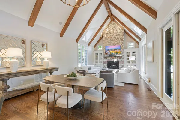 a dining room with furniture wooden floor and a chandelier