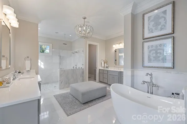 a spacious bathroom with a tub sink shower and a mirror
