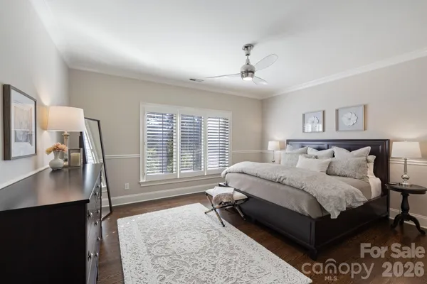 a spacious bedroom with a bed a couch and a dresser in it