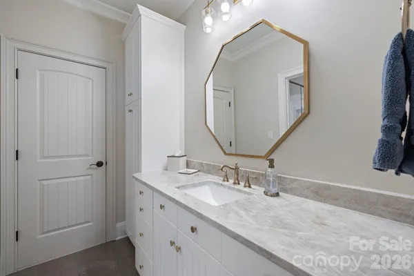 a bathroom with a double vanity sink and a mirror