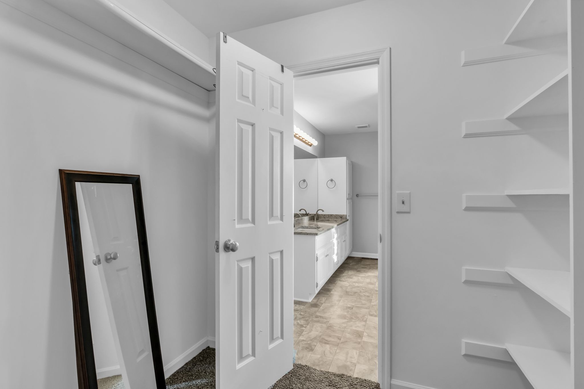 2560 Choctaw Trace Murfreesboro, TN 37129 - Photo 24 of 36 a view of a hallway with a white walls and a mirror in a room