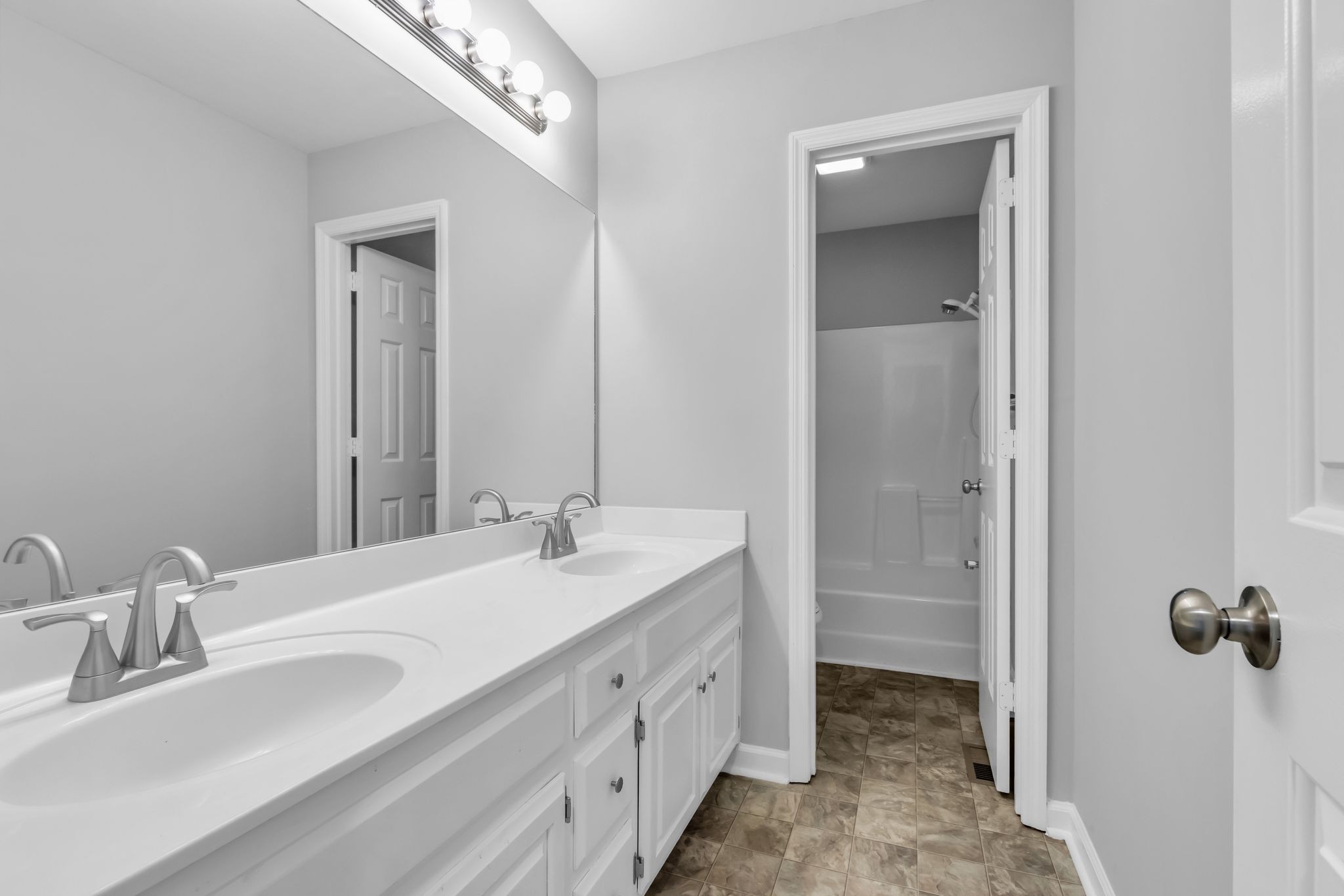 2560 Choctaw Trace Murfreesboro, TN 37129 - Photo 27 of 36 a bathroom with double vanity sinks and a mirror