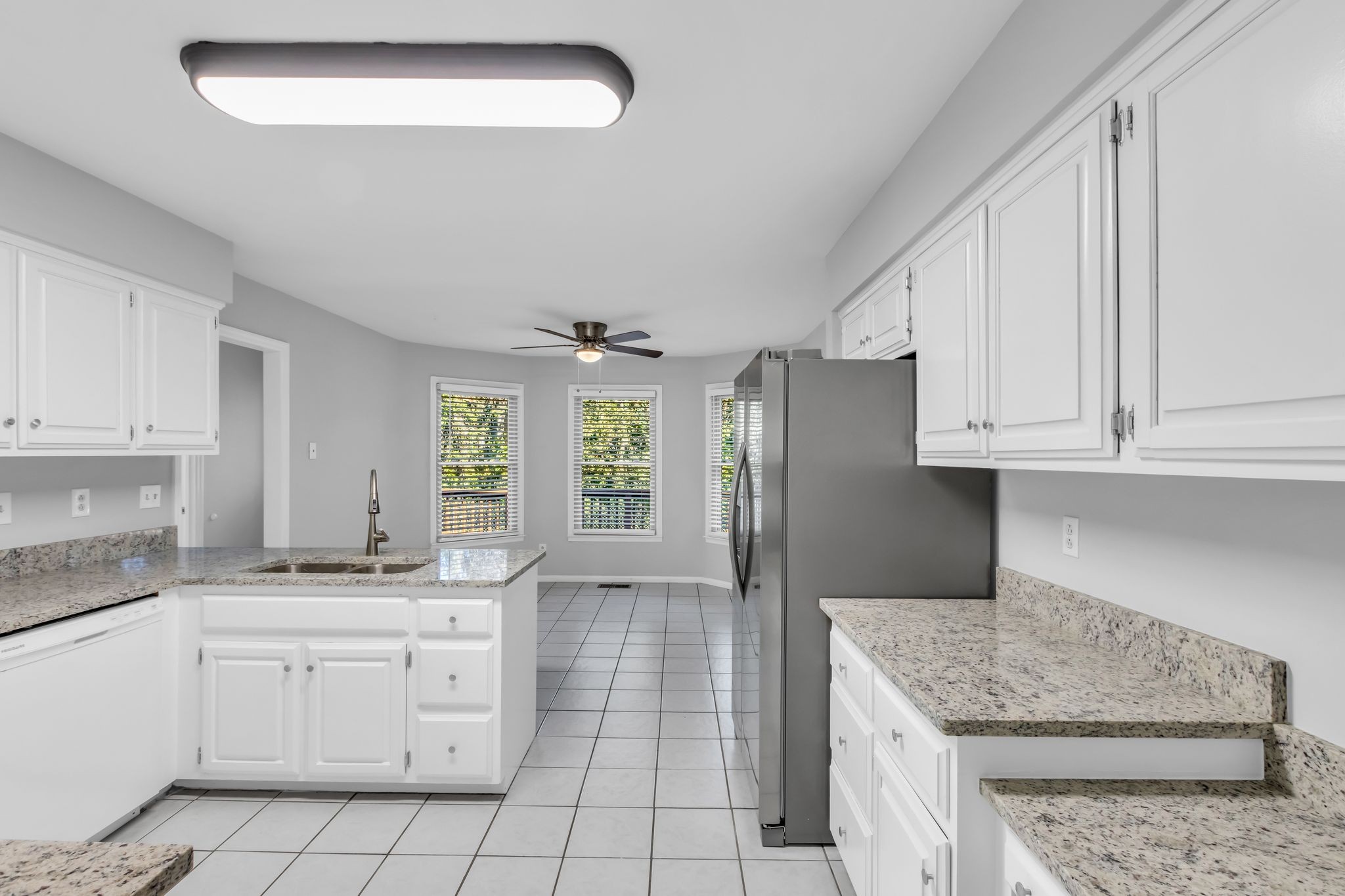 2560 Choctaw Trace Murfreesboro, TN 37129 - Photo 7 of 36 a kitchen with granite countertop white cabinets and white appliances