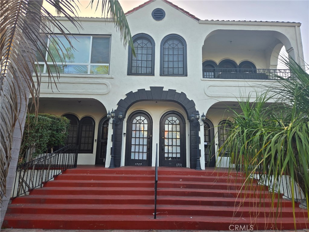 a view of two couches with the view of balcony