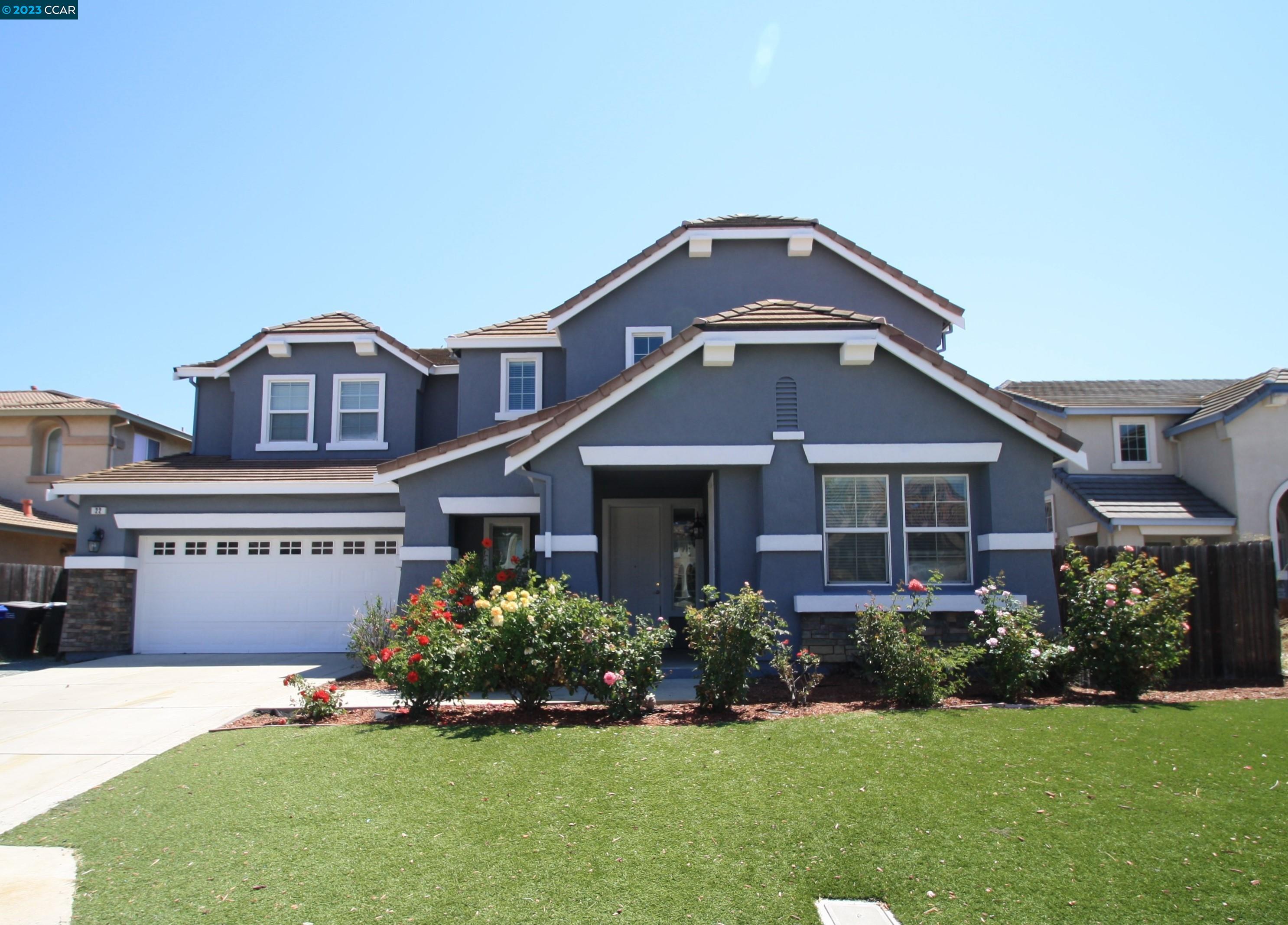 a front view of a house with a garden