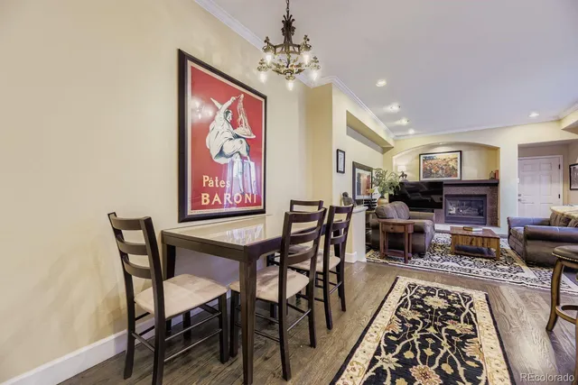 a view of a dining room with furniture a rug and wooden floor