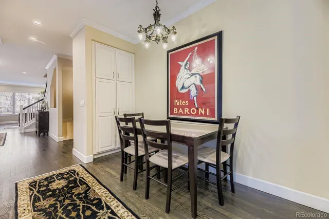 a view of a dining room with furniture wooden floor and a chandelier