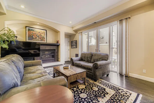 a living room with fireplace furniture and a window