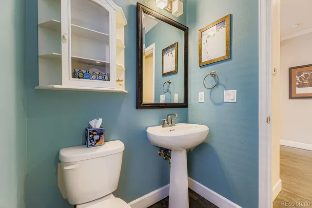 a bathroom with a sink mirror and toilet
