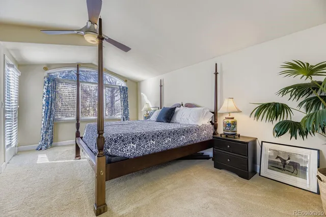 a bedroom with a bed and a potted plant