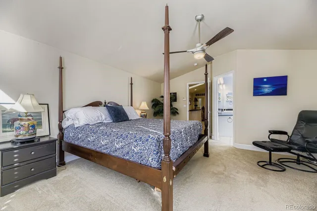 a bedroom with a bed and a desk in it