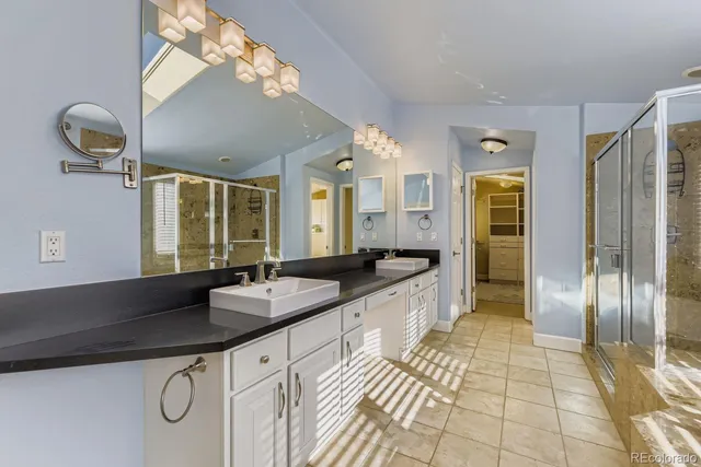 a spacious bathroom with a granite countertop sink and a mirror