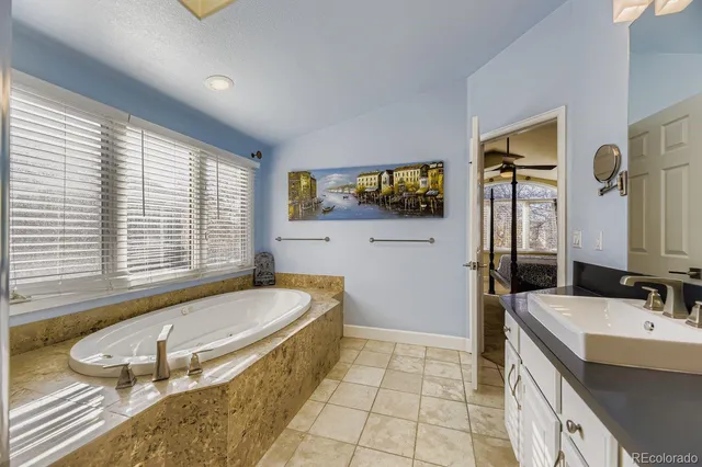 a bathroom with a tub a double vanity sink a mirror and a bathtub