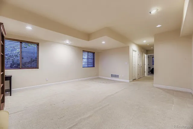 an empty room with a empty space and windows