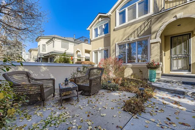 a view of a building with a chairs in a patio