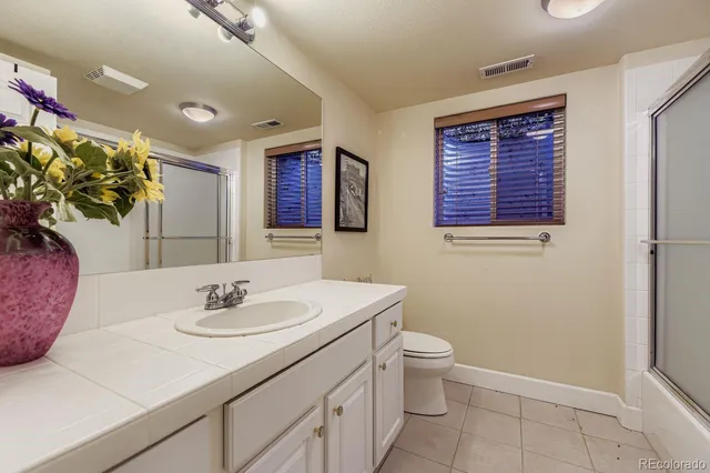 a bathroom with a sink a toilet and mirror