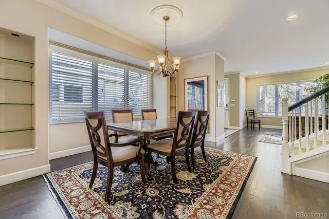 a dining room with furniture window and wooden floor