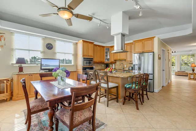 a view of a dining room with furniture and a chandelier