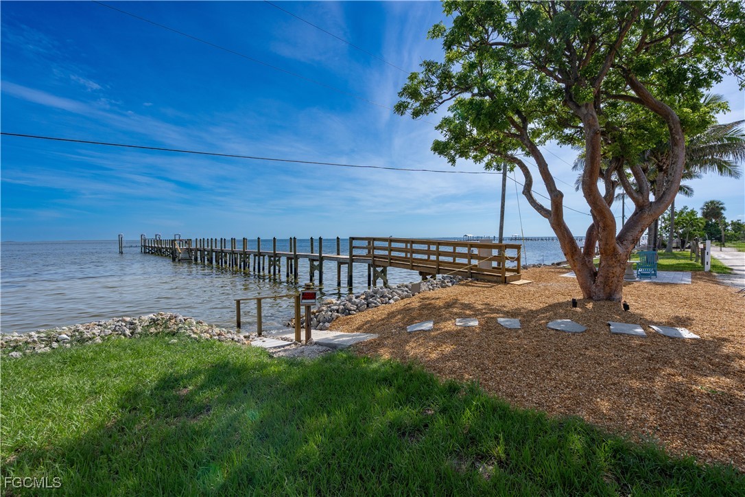 8550 Ebbtide Way Bokeelia, FL 33922 - Photo 1 of 50 a view of a backyard with a tree