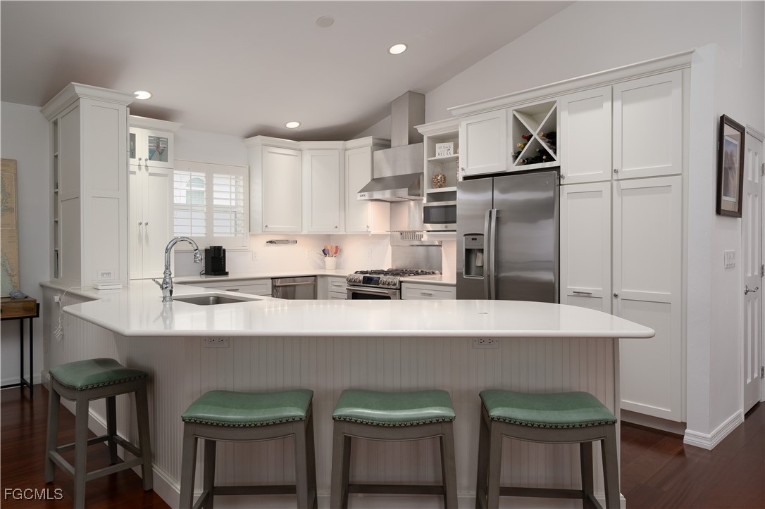 8550 Ebbtide Way Bokeelia, FL 33922 - Photo 15 of 50 a kitchen with refrigerator and cabinets