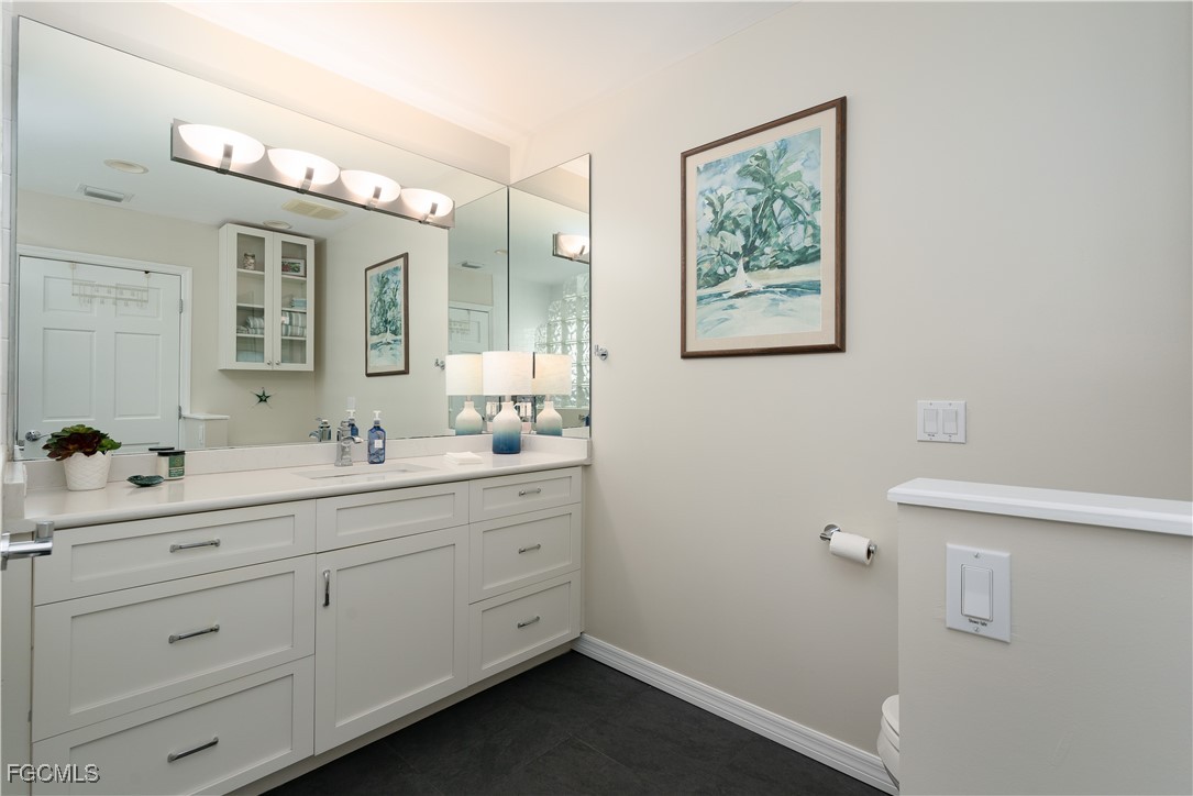 8550 Ebbtide Way Bokeelia, FL 33922 - Photo 20 of 50 a bathroom with a double vanity sink a mirror and a