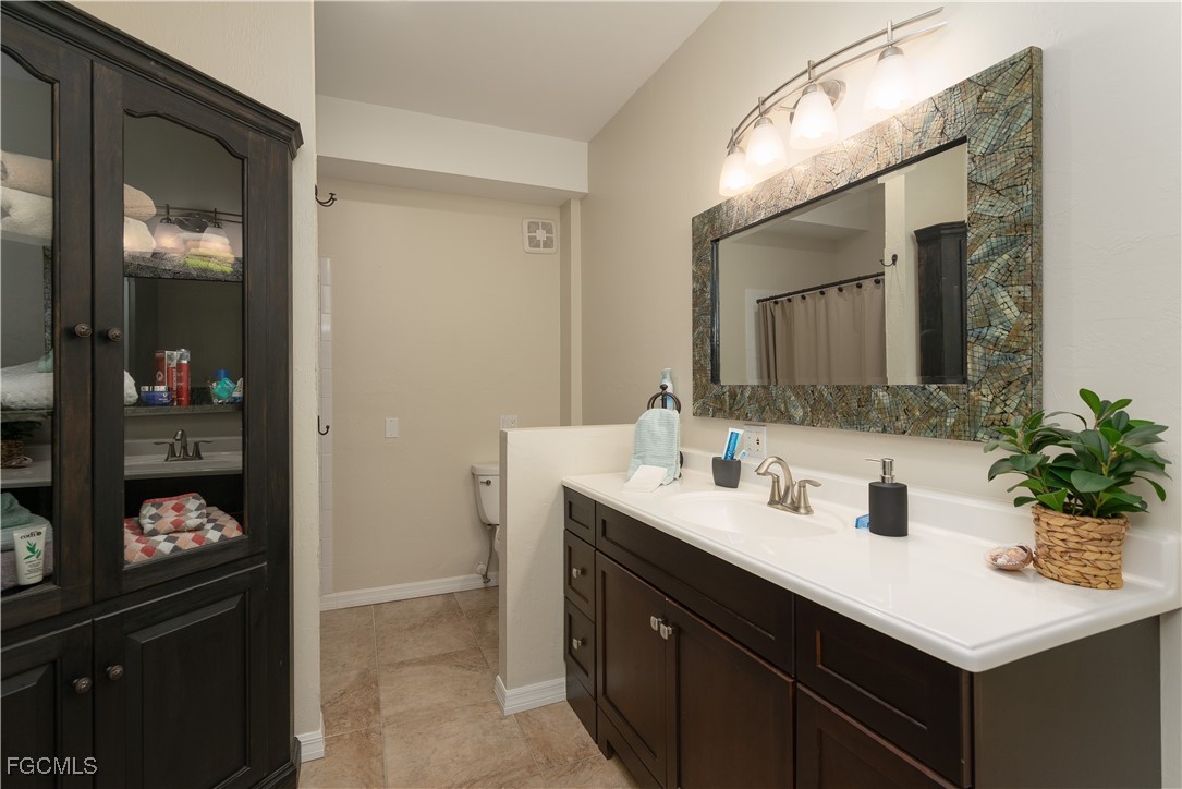 8550 Ebbtide Way Bokeelia, FL 33922 - Photo 32 of 50 a bathroom with a sink and a mirror