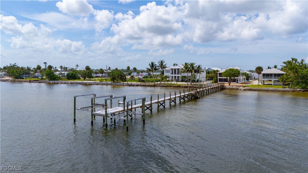8550 Ebbtide Way Bokeelia, FL 33922 - Photo 42 of 50 a view of a lake with a table and chairs