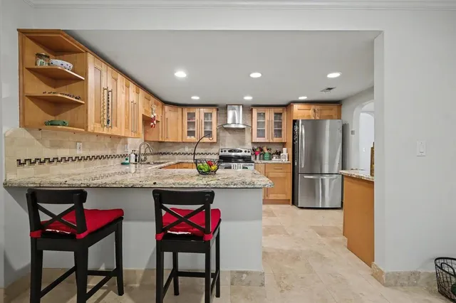 a kitchen with refrigerator and cabinets