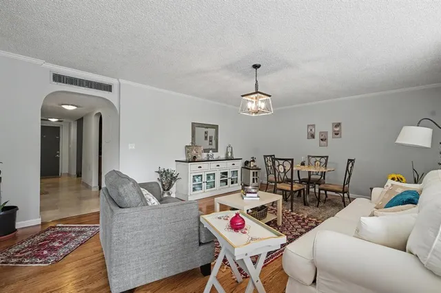 a living room with furniture and kitchen view