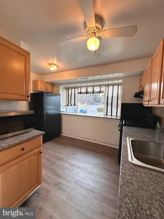 a kitchen with stainless steel appliances granite countertop a sink and a microwave