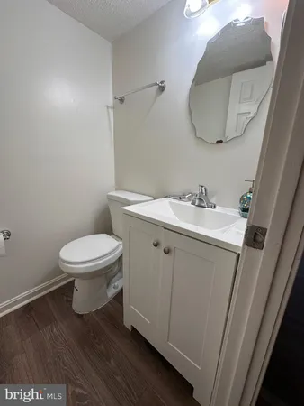 a bathroom with a sink toilet and a mirror