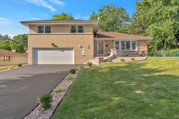 a front view of house with yard outdoor seating and green space