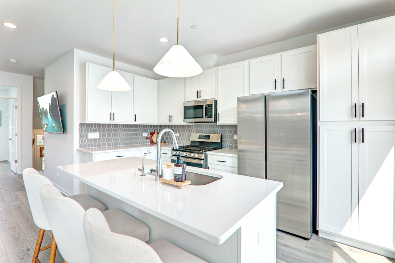 204 Timberleaf Circle Roselle, IL 60172 - Photo 8 of 22 a kitchen with stainless steel appliances a refrigerator a sink a stove a dining table and chairs