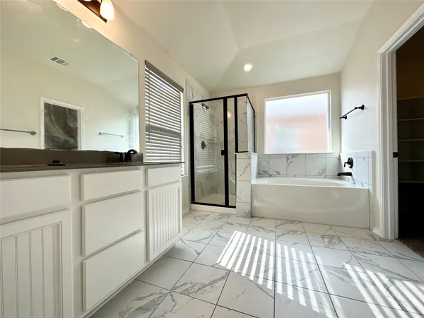 a bathroom with a bathtub and a shower